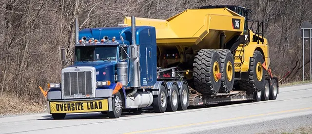 Heavy-haul trailer carrying a yellow articulated dump truck