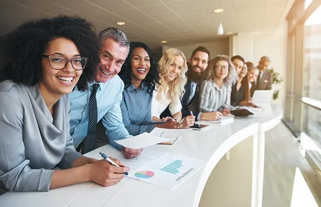 A diverse team reviewing documents together